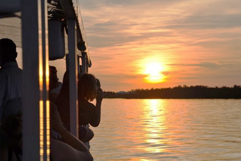 People enjoying a beautiful sunset on the Banana Bay Tour Company's Sunset & Dolphin Tour in Cape Coral, Florida, which is available for free at Xplorie participating properties.