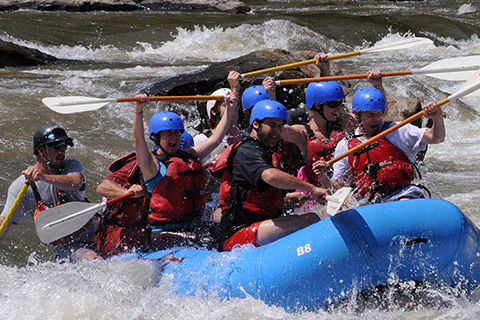 A group of people enjoy an exhilarating white water rafting adventure from French Broad Rafting in Marshall, North Carolina, which is available for free when staying at an Xplorie participating property.