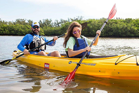 A young couple enjoys a kayak rental from Ride & paddle by Siesta Sports Rentals in Siesta Key, Florida, which is available for free to guests staying at Xplorie participating properties.
