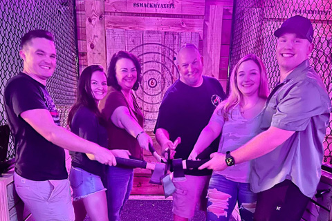 A group of people enjoying an axe throwing session at Smack My Axe in St. Pete Beach, Florida. Guests staying at Xplorie participating properties can receive a free admission.