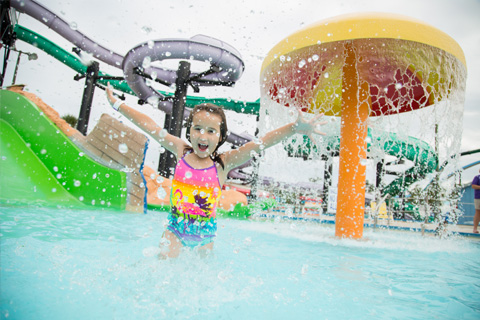 A girl plays in the water at Wild Water & Wheels in Surfside Beach, South Carolina, where guests staying at Xplorie participating properties can enjoy a free round of eighteen hole golf.