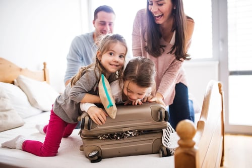 Young-family-with-two-children-packing-for-holiday.-951170976_3869x2579-min