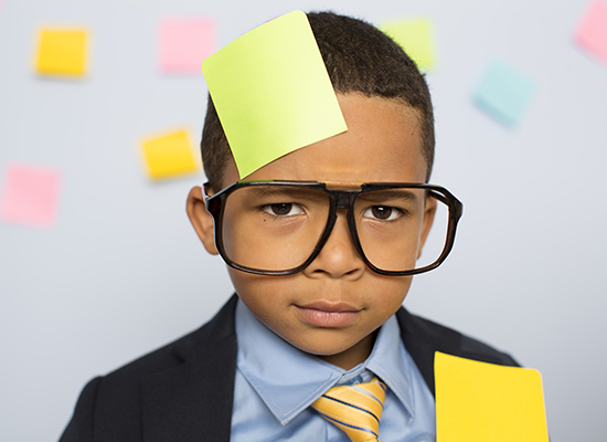 Little Boy in business suit with sticky notes everywhere looking for a new PMS System in 2019