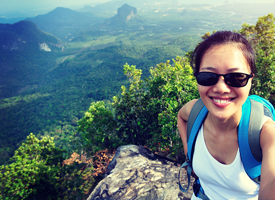 Woman on a mountain taking a selfie